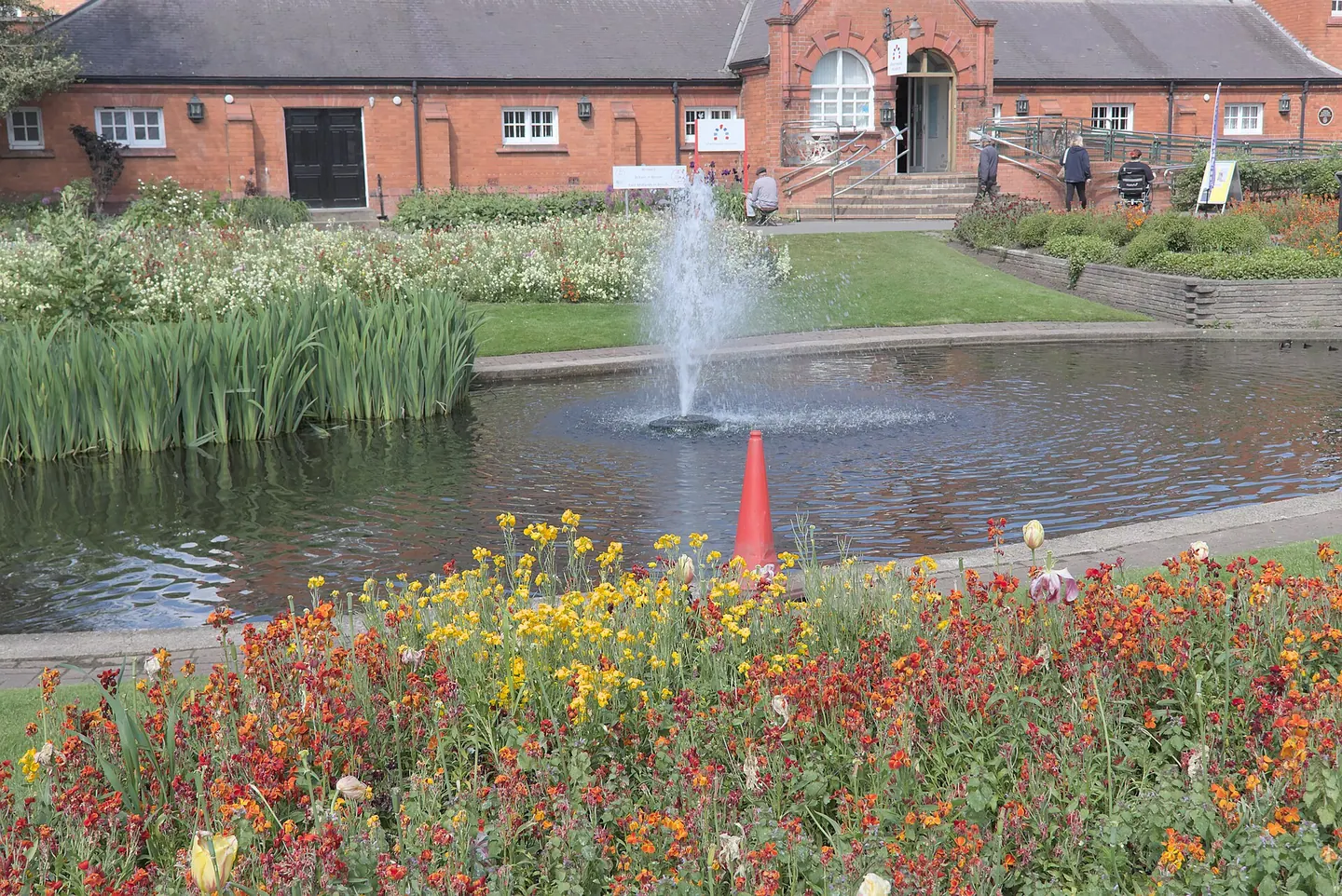The fountain on the pond in Queen's Park, Loughborough, with wallflowers in bloom