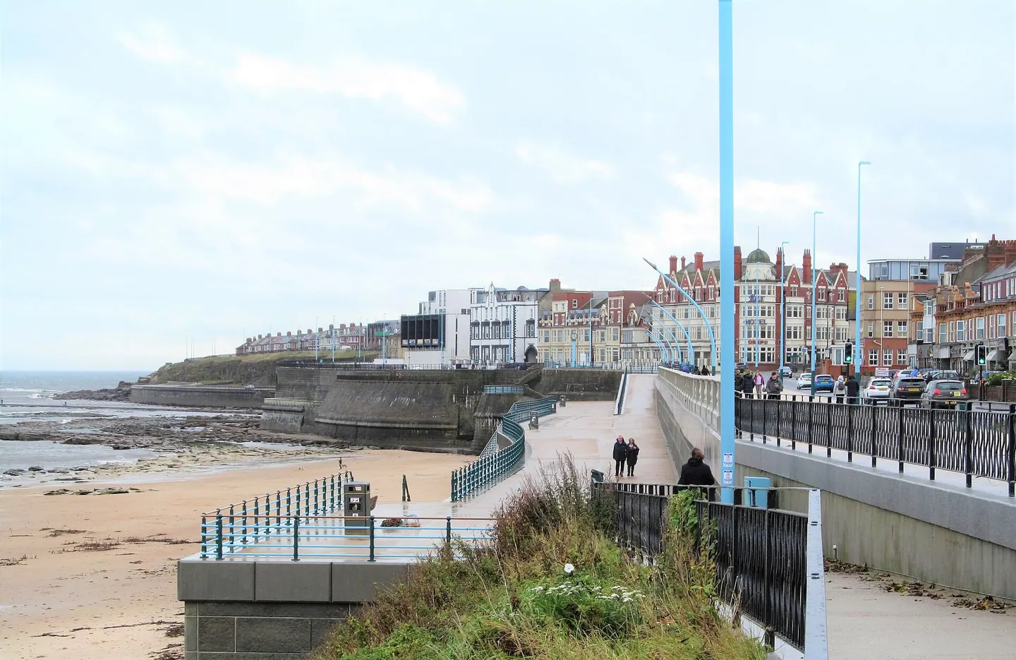 The seafront promenade at Whitley Bay, with people out walking