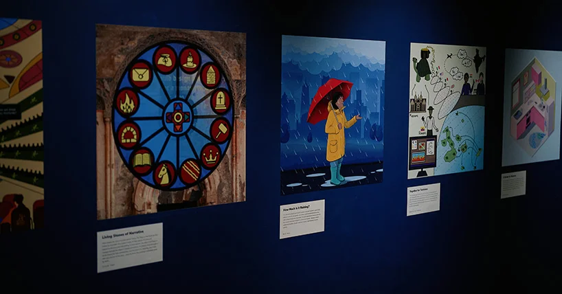 Illustrated artworks displayed along the deep blue gallery wall at the Great North Museum: Hancock in Newcastle for the Picture This: Someone Like Me exhibition.