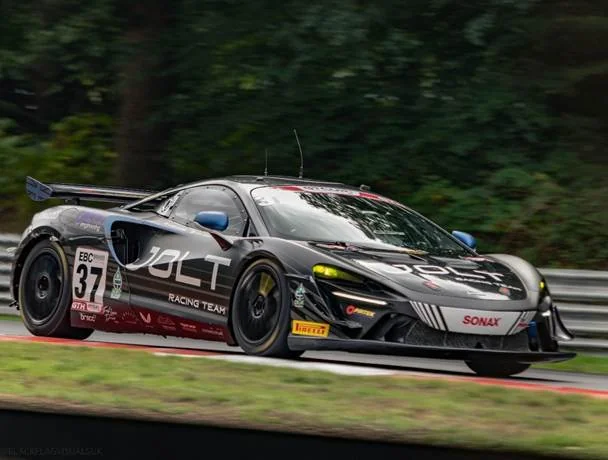 Black number 37 Jolt Racing Team GT car sponsored by Pirtek cornering at speed on a racing circuit.